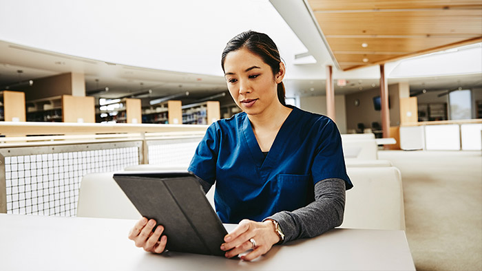 Healthcare professional using tablet device